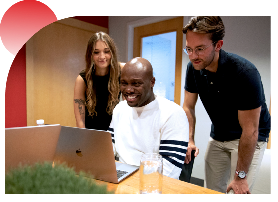 Two women and man working together at the computer
